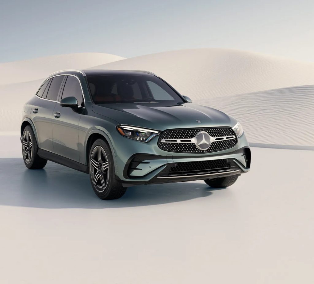 2026 Mercedes-Benz GLC in a metallic green finish, photographed at an angle highlighting its sporty front fascia and signature LED headlights.