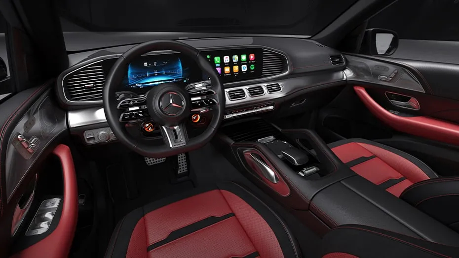 Interior of the 2026 Mercedes-AMG® GLE 53 SUV showing sport seats, steering wheel, and digital dashboard in red-and-black design.