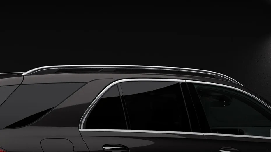 Side profile of the Mercedes-AMG® GLE 53 highlighting its aerodynamic roof rails and premium design details.