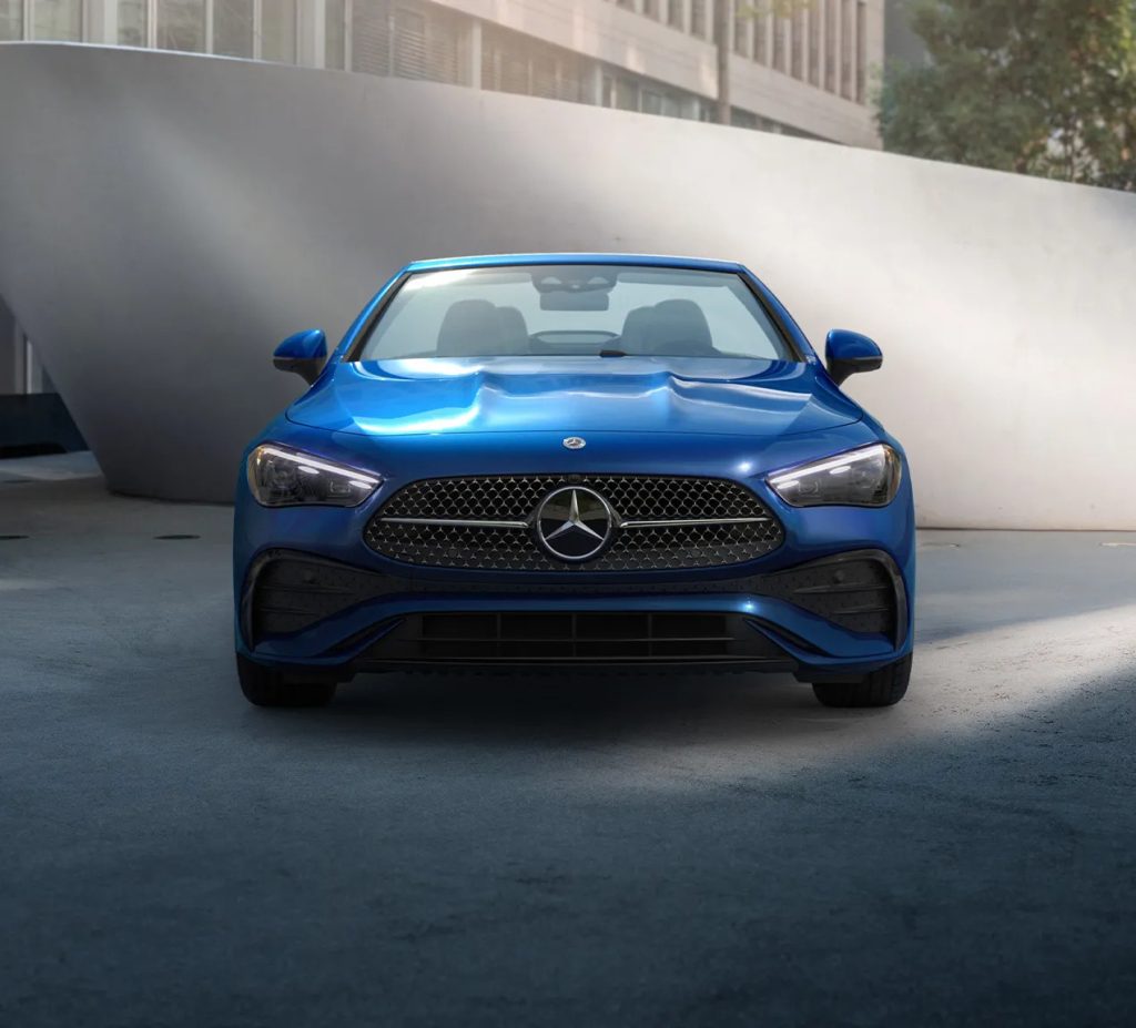 Front view of a blue Mercedes-Benz parked in a modern urban environment, emphasizing year-end tax savings opportunities.