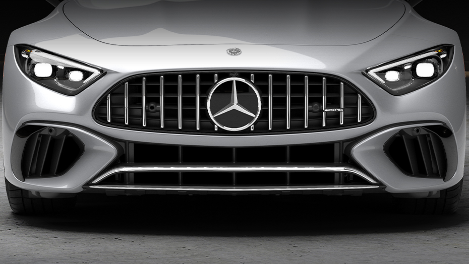 Interior view of a Mercedes-AMG® SL convertible with red leather seats, overlooking the city skyline and calm lake views.