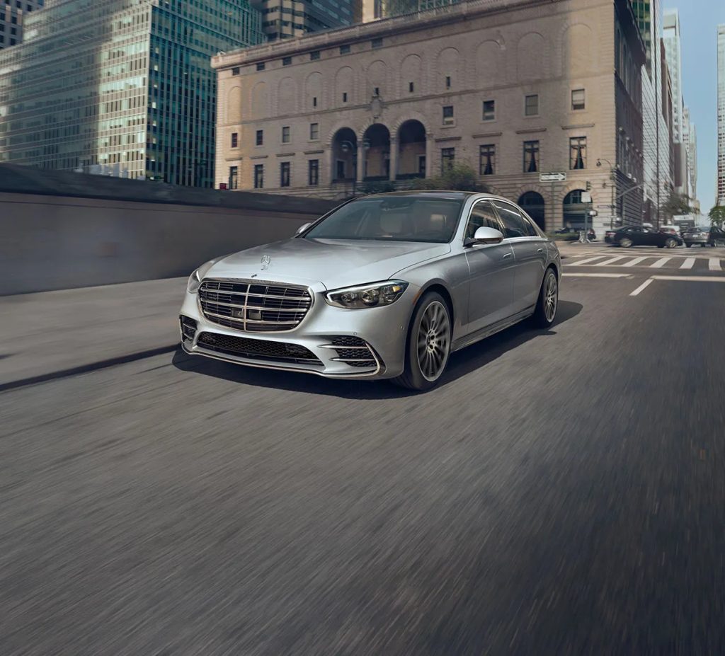 Silver Mercedes-Benz sedan driving through downtown Chicago, illustrating why now is the right time to take advantage of tax incentives.