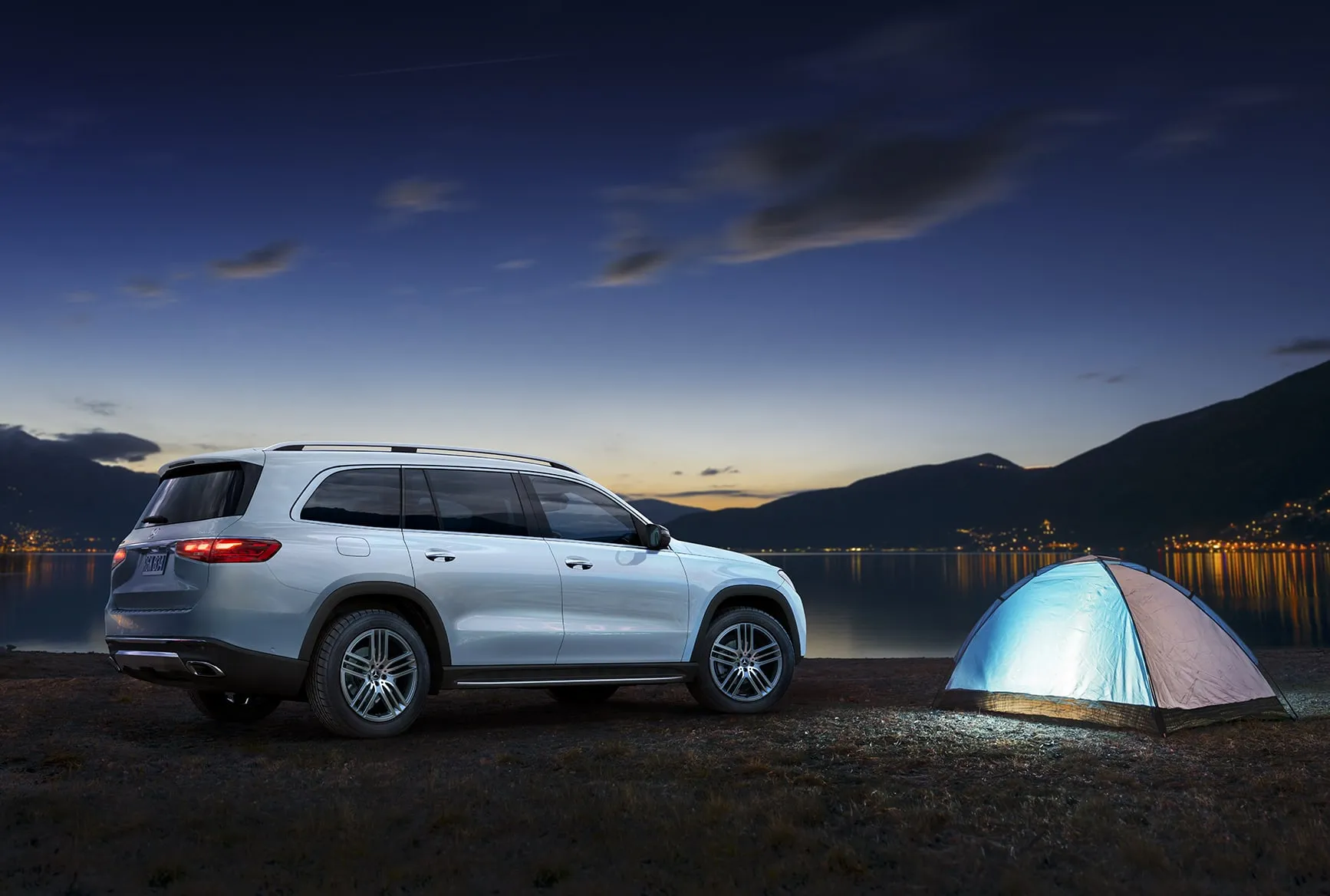 2026 Mercedes-Benz GLS parked outdoors by a lake at night, showcasing why it appeals to drivers who fit the GLS lifestyle