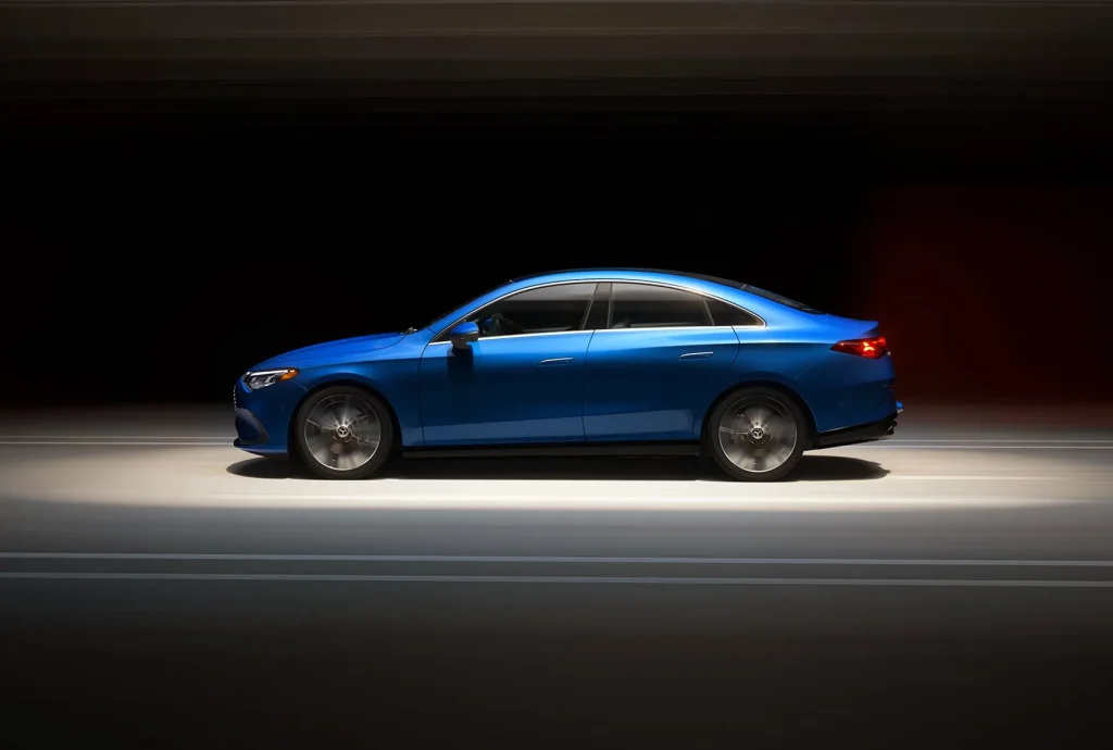 Side view of a blue new Mercedes-Benz CLA Electric in motion, emphasizing its aerodynamic sedan shape coming soon.