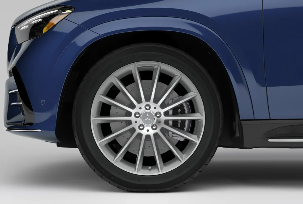 Close-up of a Mercedes-Benz luxury SUV wheel and tire, highlighting alloy wheel styling and front fender detailing on the 2027 GLE or GLS.