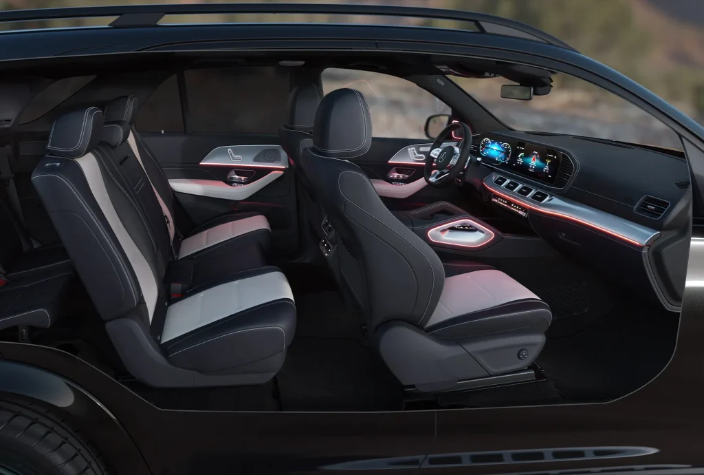 Interior cabin view of a 2027 Mercedes-Benz GLS SUV with illuminated ambient lighting, leather seats, and a three-row luxury layout.