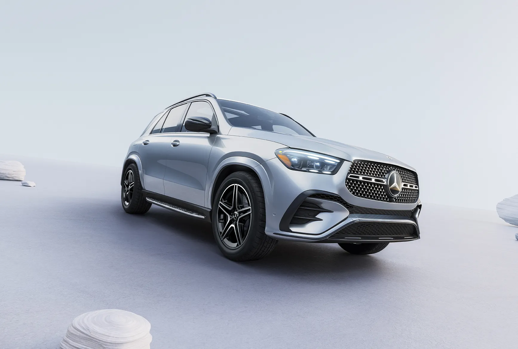 Front three-quarter view of a silver 2027 Mercedes-Benz GLE SUV showing the grille, headlights, and updated exterior styling.