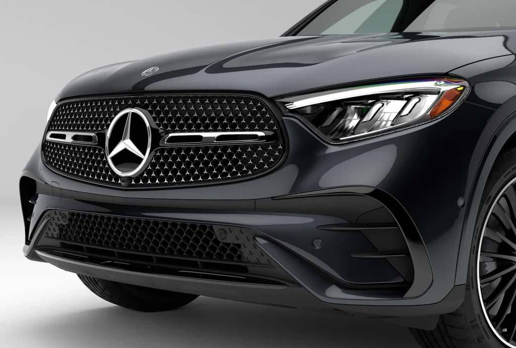 Close-up of the front grille and headlight design on a black 2026 Mercedes-Benz GLC, emphasizing its premium styling and luxury SUV character.