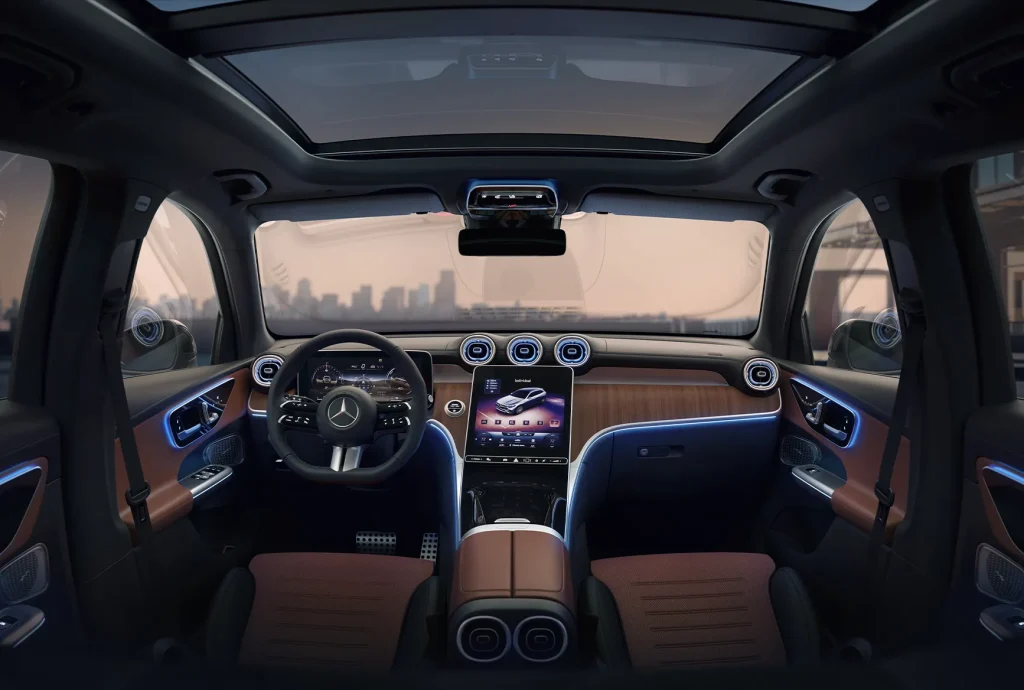Interior view of the 2026 Mercedes-Benz GLC showing the panoramic roof, digital dashboard, ambient lighting, and premium cabin design.