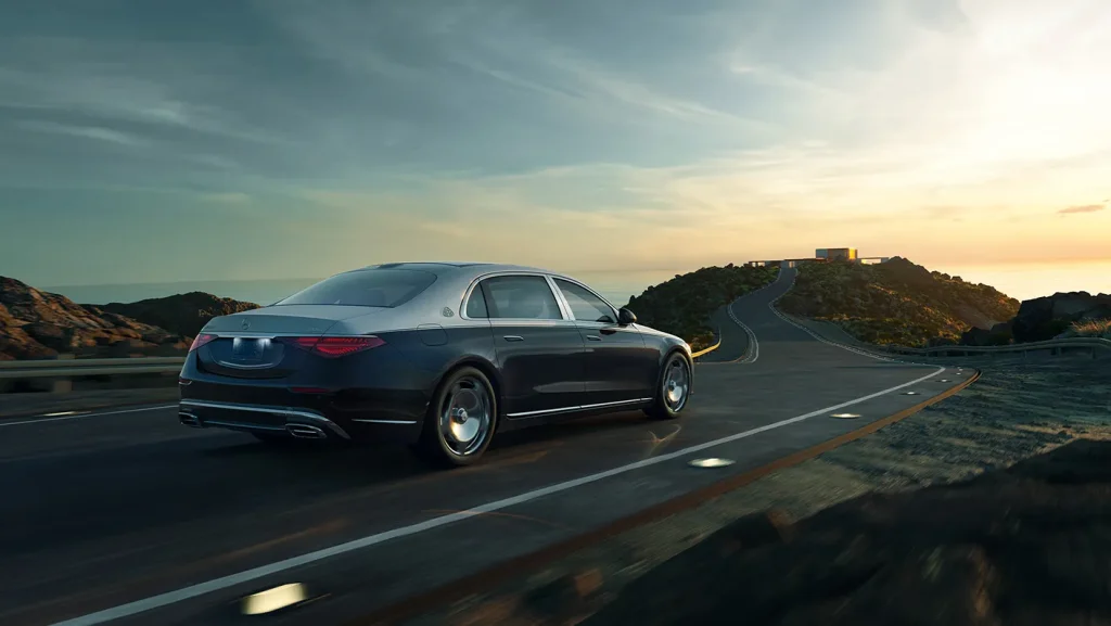 Mercedes-Benz luxury sedan driving on open road demonstrating 4MATIC capability in Illinois weather