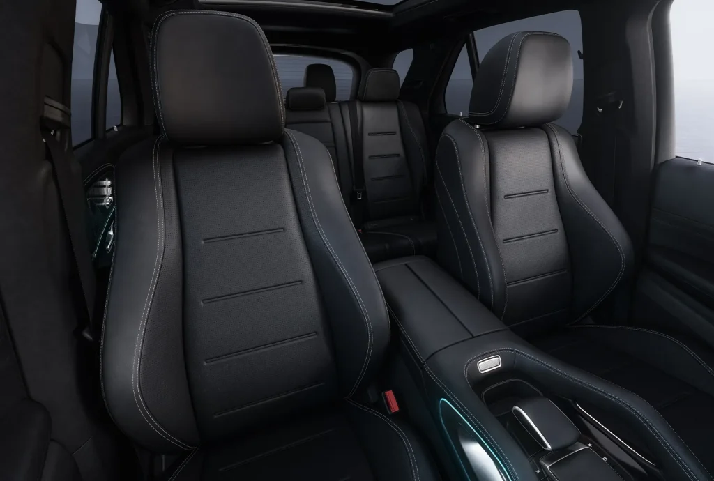Front interior seating area of a Mercedes-Benz SUV with black leather seats and center console, highlighting comfort in the best Mercedes-Benz family cars available right now.