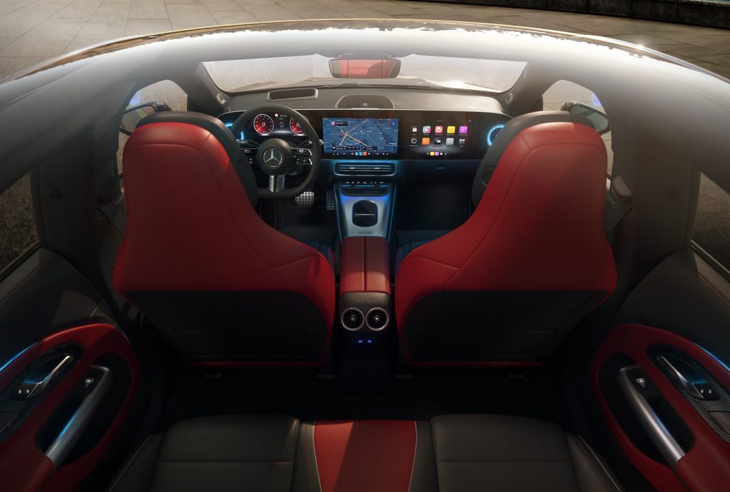 Interior of the all-electric 2026 Mercedes-Benz CLA with red seats, digital dashboard, MBUX screen, and premium luxury cabin design.