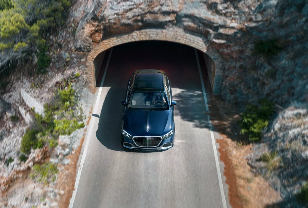 2027 Mercedes-Maybach S-Class ultra-luxury sedan driving through a rock tunnel.