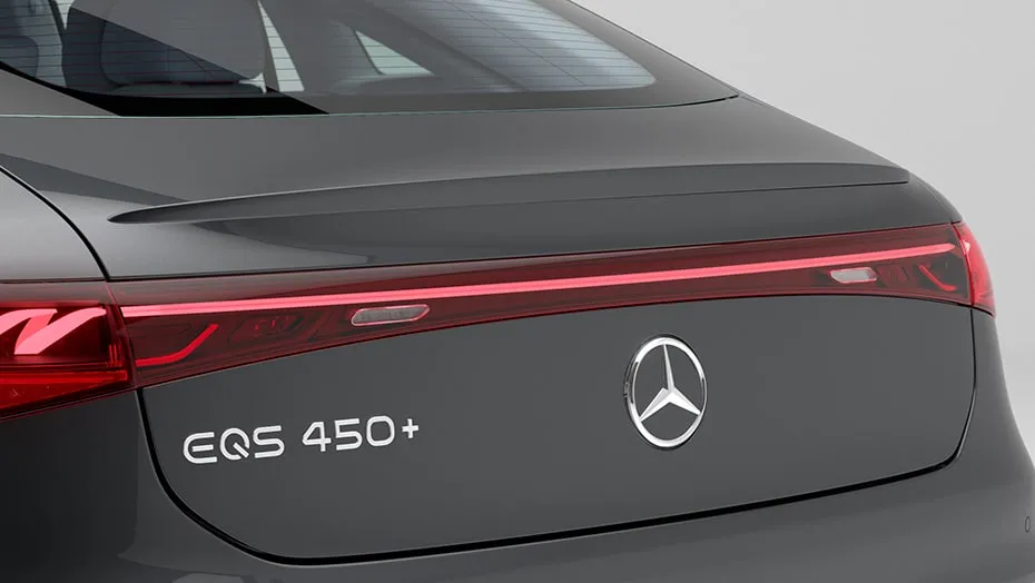 Rear close-up of the Mercedes-Benz EQS 450+ badge with sleek LED taillight styling