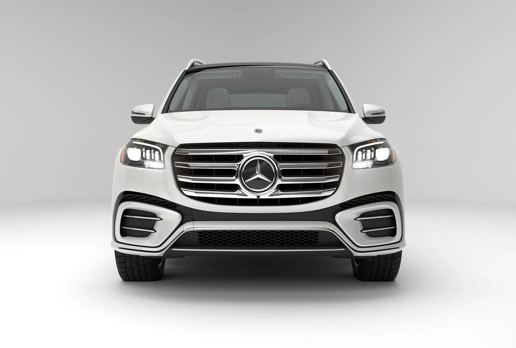 2027 Mercedes-Benz GLS white luxury SUV shown from the front with Mercedes-Benz grille and LED headlights.