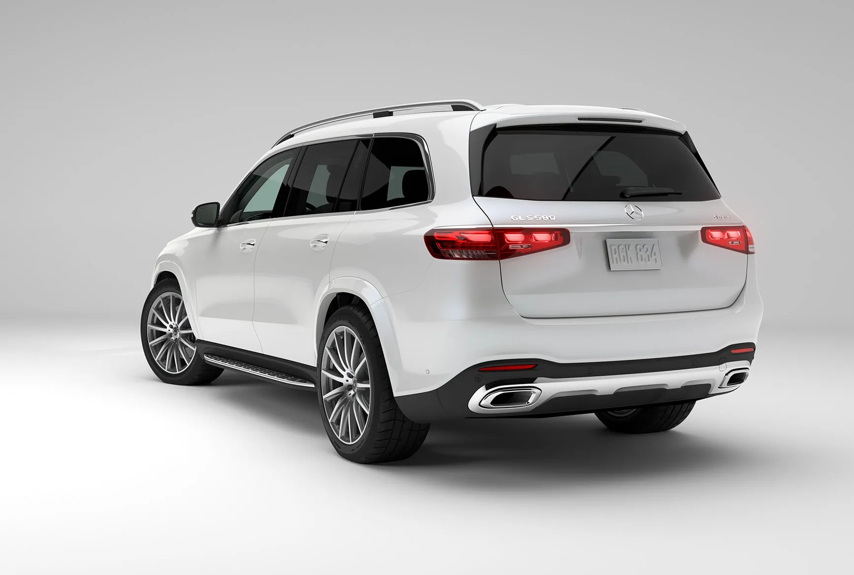 2027 Mercedes-Benz GLS white luxury SUV shown from the rear with LED taillights and chrome exhaust details.