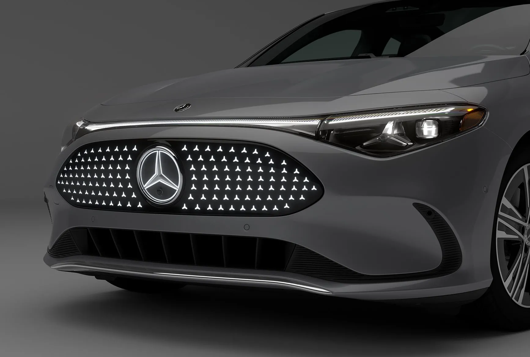 2027 Mercedes-Benz CLA Shooting Brake close-up of front grille, LED headlights, and Mercedes-Benz badge.