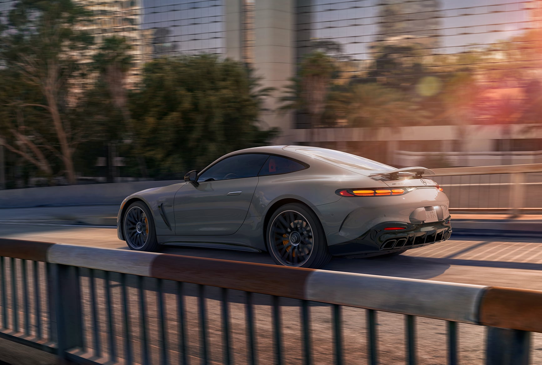 Rear view of the 2027 Mercedes-Benz AMG GT 55 Coupe driving through the city.