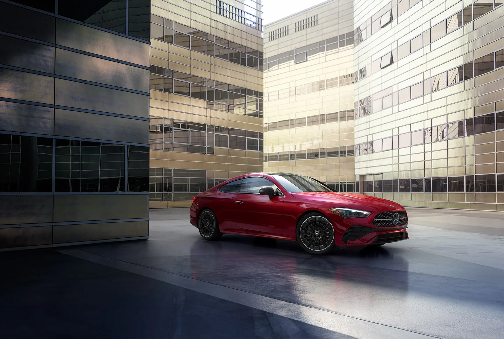2027 Mercedes-Benz CLE Coupe red side view parked between modern city buildings.