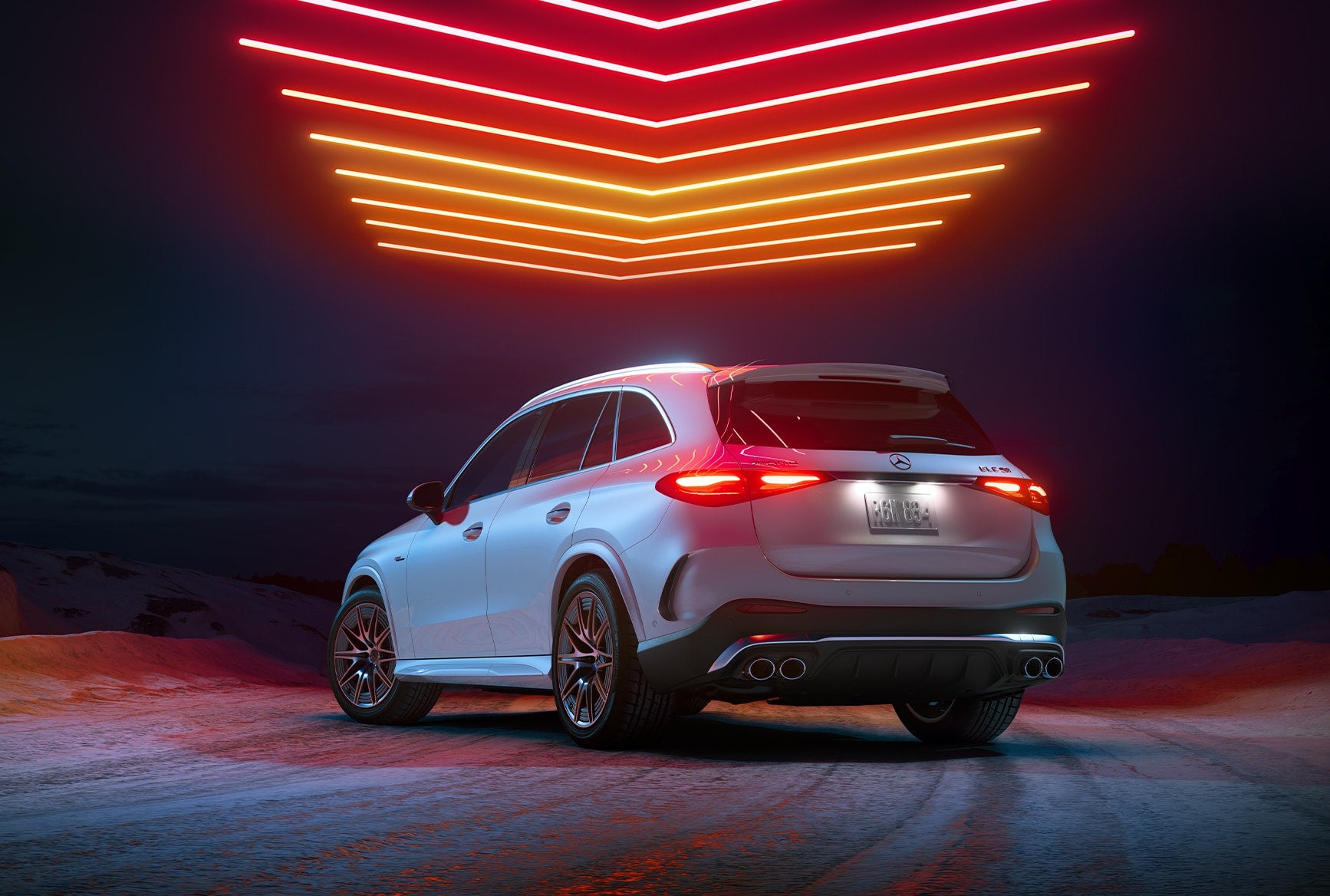 Rear three-quarter view of the 2027 Mercedes-AMG GLC 53 SUV beneath red and orange lights.
