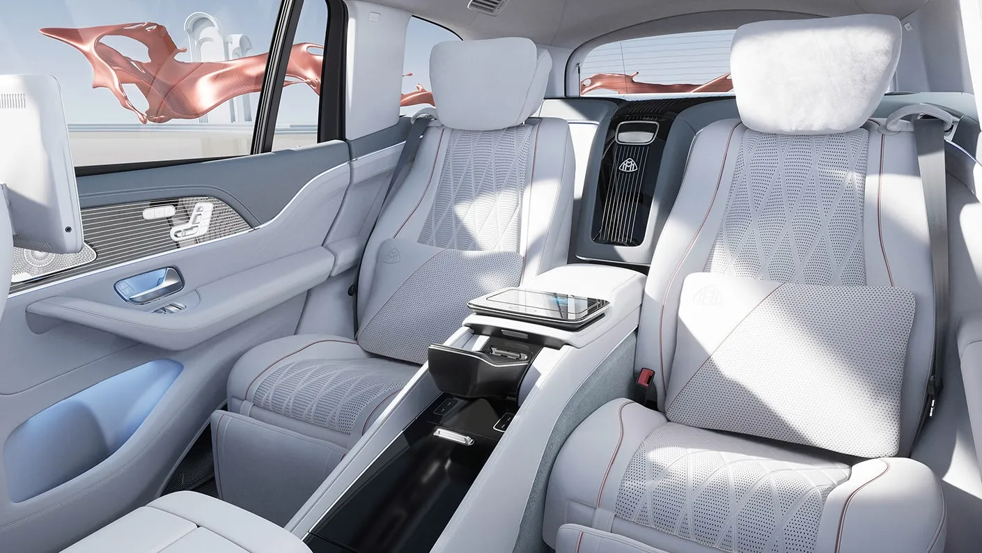 Mercedes-Maybach GLS rear cabin featuring executive white leather seats, center console, pillows, and luxury passenger comfort
