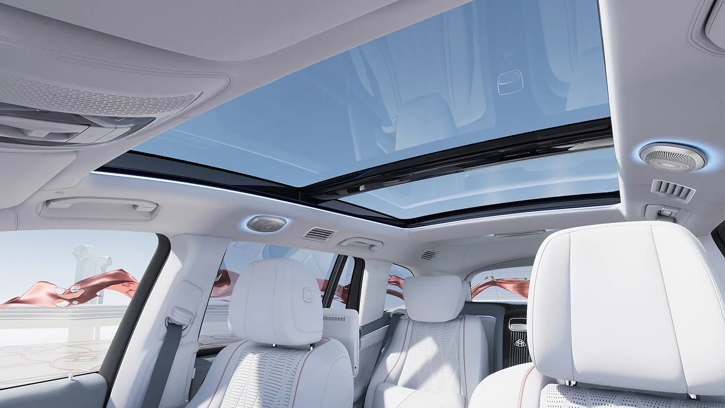 Mercedes-Maybach GLS interior with panoramic glass roof, white leather seats, ambient lighting, and premium rear cabin design