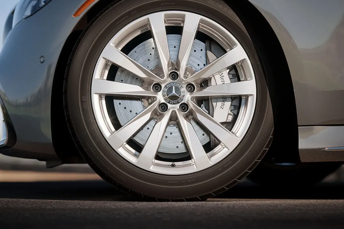 Close-up of the Mercedes-Benz S-Class alloy wheel and braking system, symbolizing 4MATIC® all-wheel drive and AIRMATIC® suspension engineering.