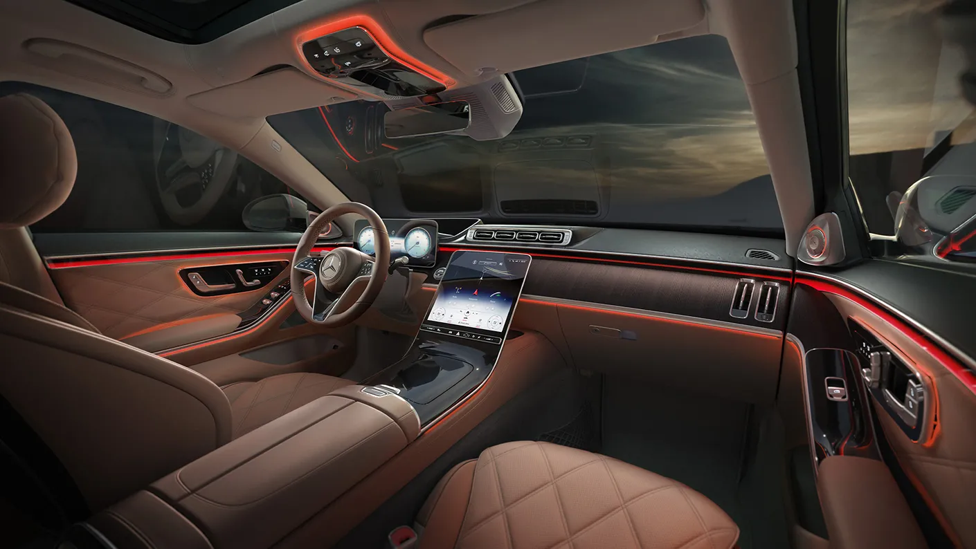 Mercedes-Maybach S-Class front interior showing the MBUX luxury digital cockpit, touchscreen display, and ambient lighting