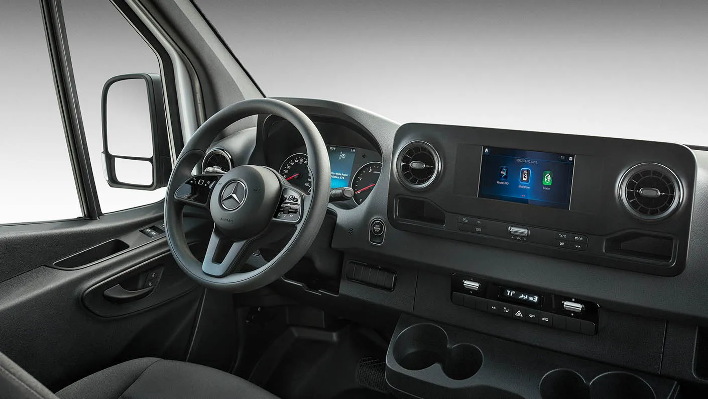Close-up of Mercedes-Benz Sprinter infotainment screen and climate controls.