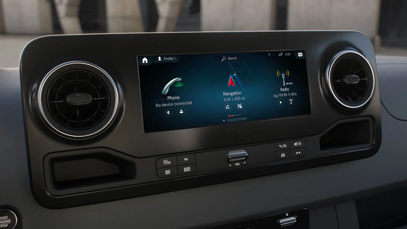 Mercedes-Benz Sprinter cabin interior with steering wheel and digital instrument cluster.