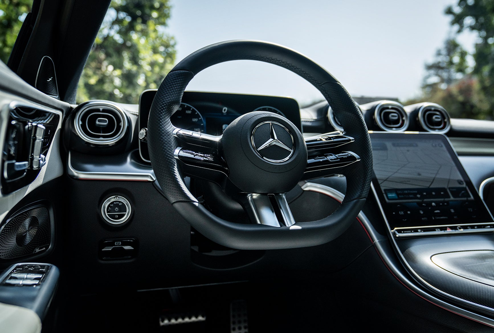 Mercedes-Benz C-Class steering wheel and dashboard showcasing premium materials and advanced controls