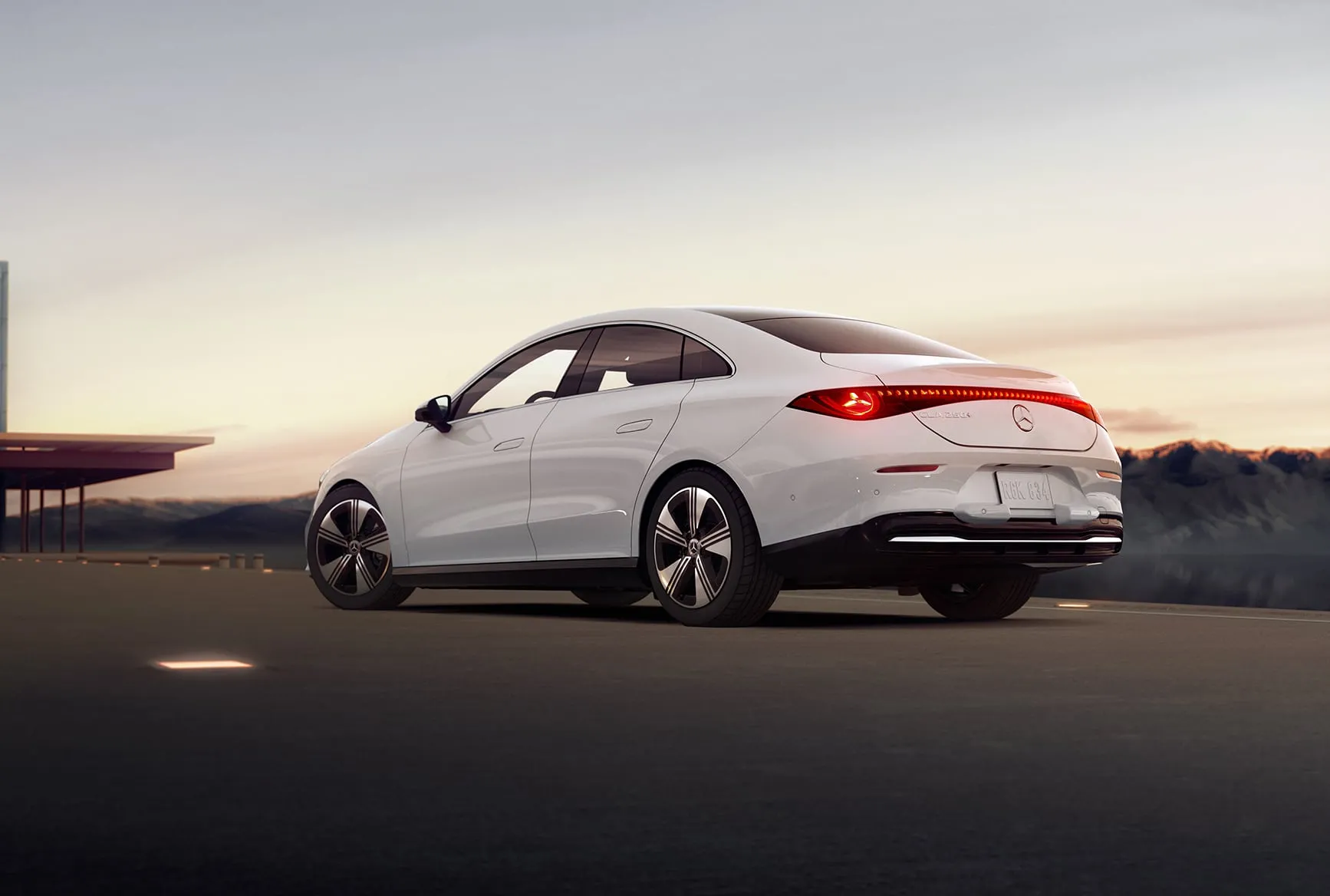 White Mercedes-Benz CLA rear angle showing slim LED taillights and sporty coupe styling