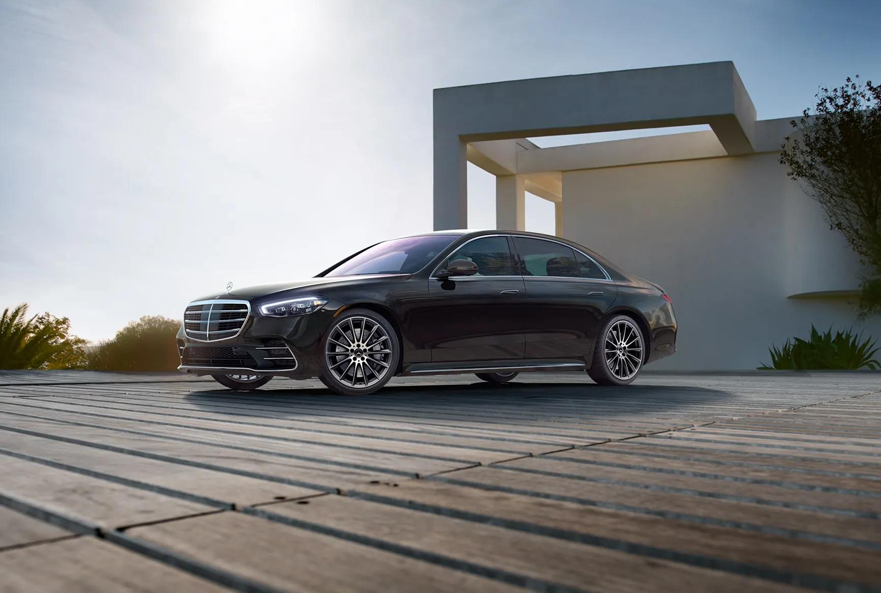 Mercedes-Benz S-Class parked near modern architecture highlighting elegant design
