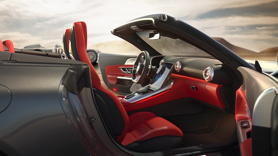 Mercedes-Benz SL interior with red seats and open convertible roof, showing a premium luxury cabin.