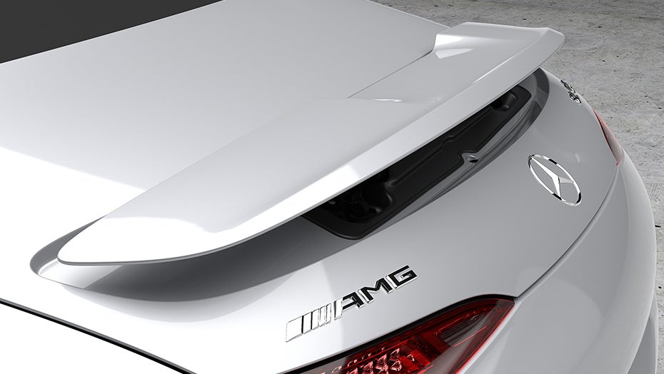 Rear section of the Mercedes-Benz SL with raised spoiler and AMG badge, highlighting sporty exterior details.