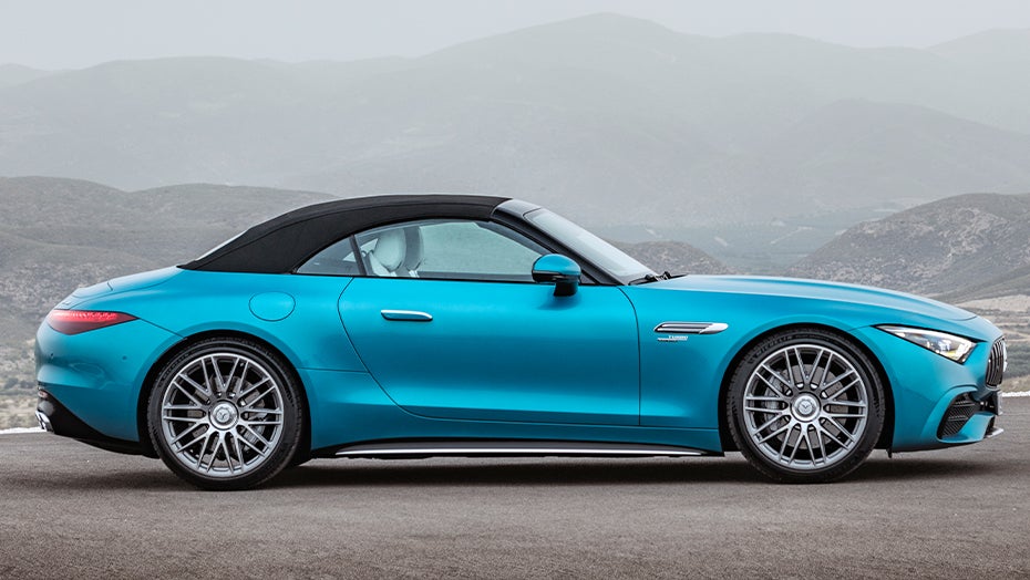 Mercedes-Benz SL in blue with a soft top, shown from the side with a sleek and sporty roadster design.